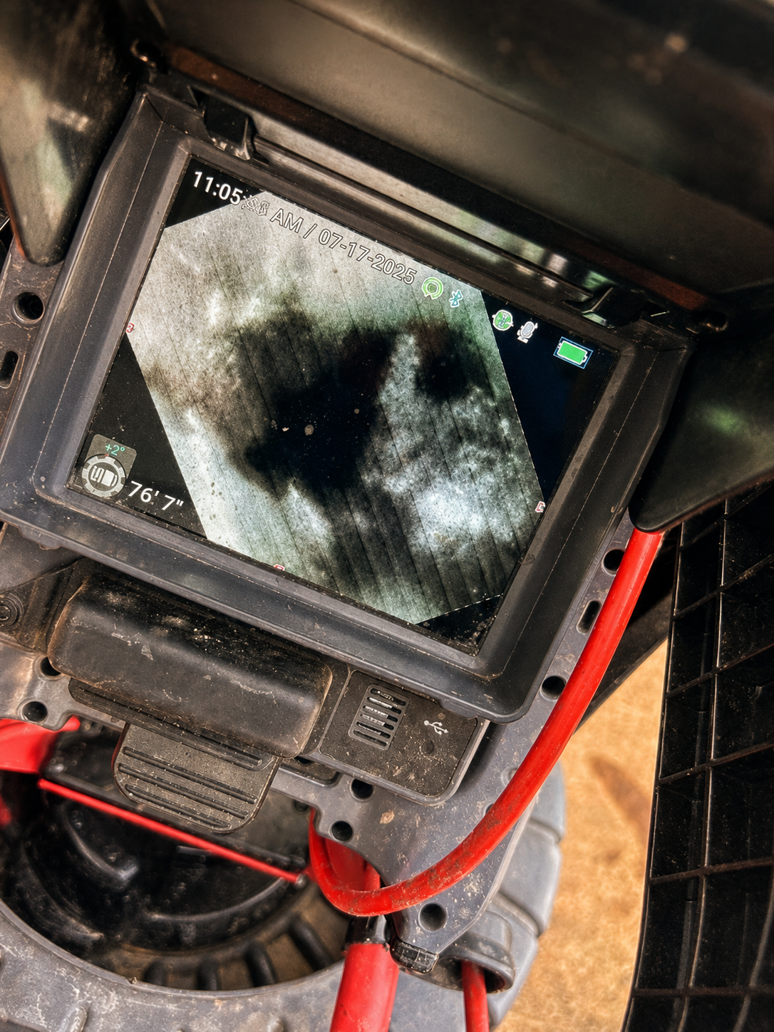 Sewer camera inspection monitor showing the live video feed inside a residential line